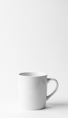Obraz premium A white ceramic mug with a handle sitting on a white surface with a white background