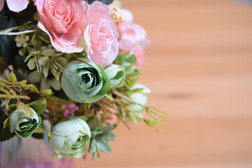 A photograph of beautiful flowers arranged in a vase, taken indoors