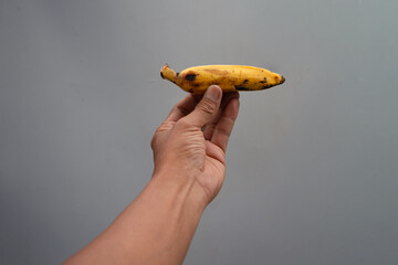 Hand holding a banana