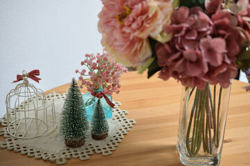 A photograph of beautiful flowers arranged in a vase, taken indoors