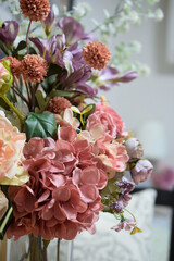 A photograph of beautiful flowers arranged in a vase, taken indoors