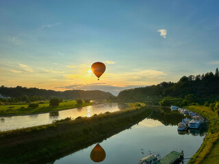Hot air balloon over the river Elbe in the evening