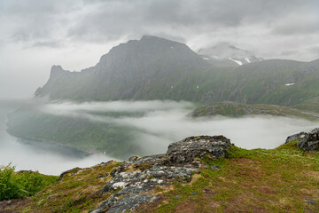 Mountains on Norwegian senja island, view on Ørnfjorden a branch of Øyfjorden. View from hiking trail towards Barden mountain peak into the fjord. Arctic travel destination in northern europe. Amazing
