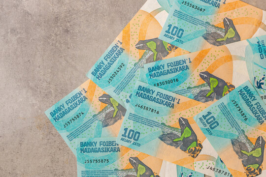  Madagascar money. 100 ariary banknotes with a frog. Business background, financial concept, copy space. flat lay