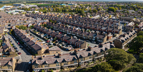 Aerial view above rows of back to back terraced houses on a large council estate