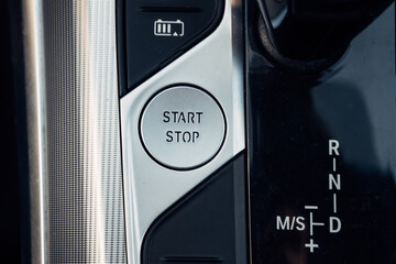 Start-stop button of a modern hybrid car, close-up of vehicle control and technology