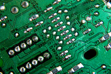 Green electronic printed circuit board with many tracks and electronic components