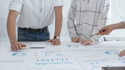 Group of business people is collaborating in modern office environment, analyzing financial data and charts, evaluating performance and developing company growth strategy