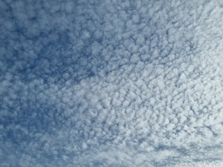 Fototapeta premium Sky Textures: A vast expanse of textured sky, where soft clouds and the expansive atmosphere converge in a mesmerizing display of nature's artwork.