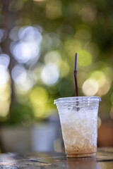 An ice-cold coffee with a refreshing slice of lemon and a straw is the perfect summer refreshment