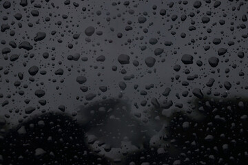 Fresh blue water droplets form an abstract pattern on a clean glass surface