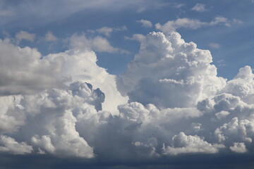 Celestial Tapestry: A dramatic skyscape features billowing cumulus clouds, offering a breathtaking panorama of celestial artistry and boundless atmospheric expanse. 