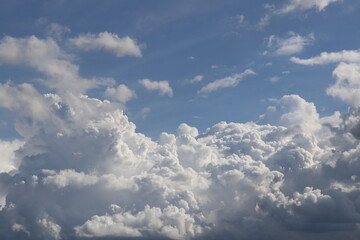 Sky of Whispering Clouds: A breathtaking display of towering cumulus clouds drift majestically...