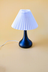 White table lamp on a color background.