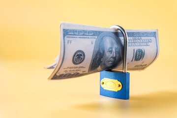 Locked Blue Padlock with bank note,concept of financial safety.