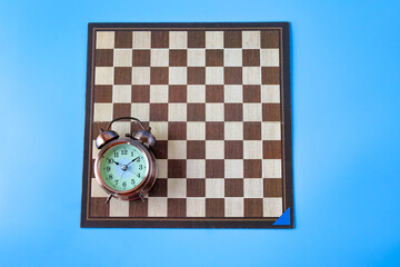 Alarm clock on chessboard ,strategy and time concept