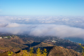 Marine layer rolling in over the Pacific Coast and Getty Villa, taken from Parker Mesa Overlook .