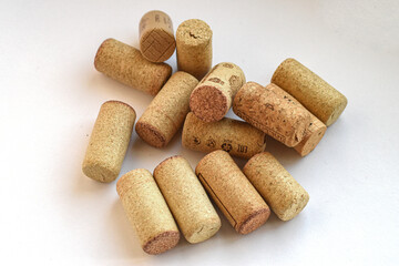 Pile of cork stoppers. Large pile of natural wine cork stoppers on white background, symbol of wine culture and eco material.