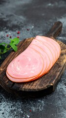 Sliced ham on wooden board