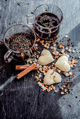  mulled wine in two glasses with heart-shaped cookies  and spices  arranged on a grey slate background