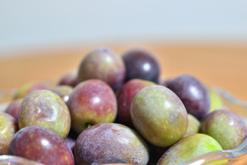 A photograph of ripe olives taken indoors
