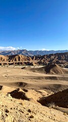 Expansive desert landscape under a clear blue sky