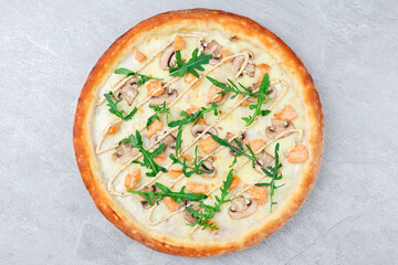 White Sauce Pizza with Chicken, Mushrooms, Arugula, and Drizzled Dressing on Crispy Crust over Gray Stone Background