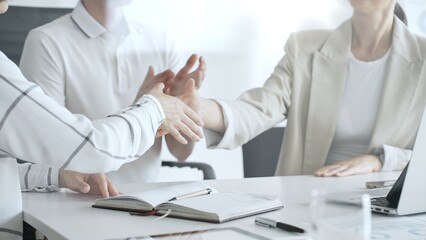 Business people shaking hands after successful negotiation, colleagues clapping, celebrating agreement in modern office headset. Handshake concept, close up view