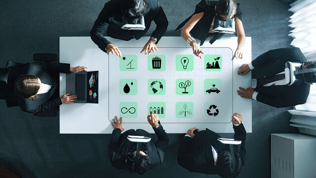 Aerial view of business professionals engaged in a collaborative meeting using virtual reality technology to explore innovative ideas and solutions in a modern office environment. Trope