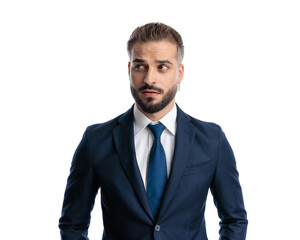 curious mature businessman in navy blue suit looking to side