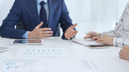 Business team engaging in a corporate meeting, discussing strategies while analyzing financial...