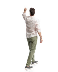 rear view of casual man pointing finger up in the sky while walking