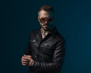 Fototapeta premium dramatic fashion man with cool sunglasses and necklace posing