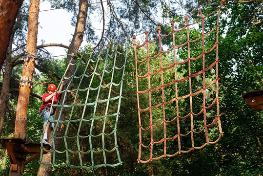Child climbing rope net outdoors