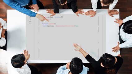 A dynamic business meeting featuring a diverse team of programmers collaborating on coding tasks using a tablet. Fostering innovation and teamwork. Raster