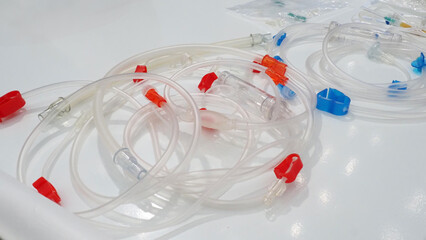 A set of medical infusion and tubing lines with connectors in red and blue and transparent parts