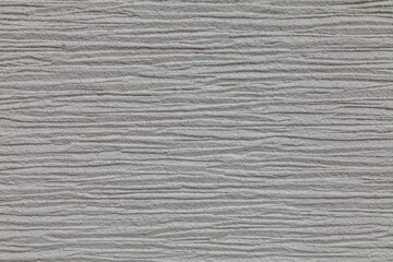 Fototapeta premium Gray wall with a pattern of lines. The wall is made of concrete and has a rough texture.