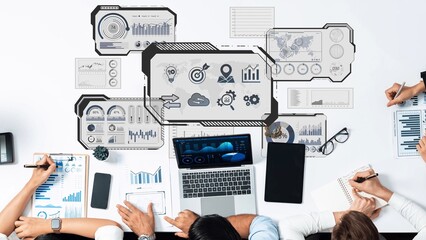 A top-down view of a collaborative business meeting with professionals discussing data analysis, charts, and insights for effective strategy planning. Raster