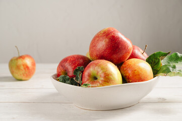 Red apples from garden, in a bowl lifestyle, top view. Autumn abstract food background
