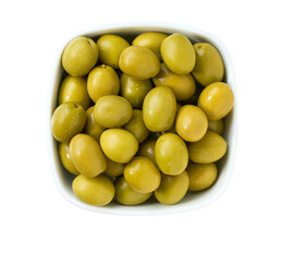 marinated green olives in a white ceramic bowl isolated on a white background. Top view.