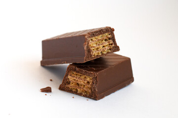Chocolate Candy Bar with Wafer Bite. Chocolate candy bar with wafer filling partially bitten, showing layers.