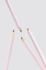 Modern pink lip liner on soft grey background