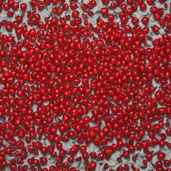 A dense scattering of vibrant red candy sprinkles creates a textured and visually striking background, perfect for festive and celebratory designs