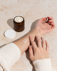 Woman using beef tallow moisturizer with swipe on arm