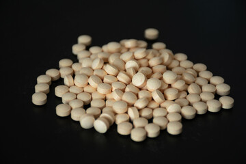Close-up of various round tablets. Ideal for healthcare, medicine promotions, and discussions about medications and treatments.