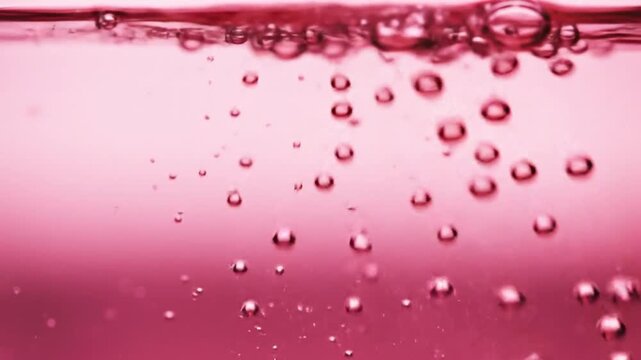 Vibrant Pink Liquid with Effervescent Bubbles Rising to the Surface in a Dynamic CloseUp Shot.