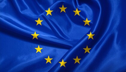 European Union flag with twelve gold stars on blue, slightly wrinkled fabric, symbol of unity and harmony.