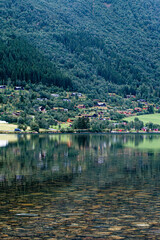 Fjords of Norway with beautiful mountains and landscapes, lake and roads in mountains, peaks in ice and snow and forests of Scandinavia