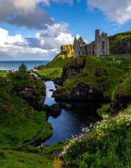 Naklejka premium Ruined castle overlooking a scenic waterway