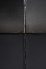 photograph of folded paper print with deep crease lines, creating a geometric cross shape and textured surface.